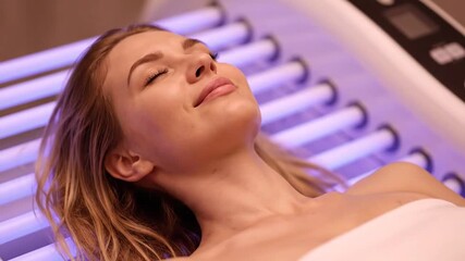 Woman Undergoing UV Light Therapy for Skin Treatment in a Medical Spa Setup with Relaxed Expression and Soothing Ambiance for Health and Beauty Advertisements and Promotional Material