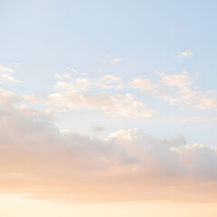 Gentle pastel sky with soft clouds at sunset, creating a serene and peaceful atmosphere