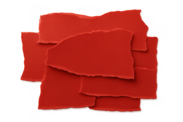 Overlapping red torn paper scraps creating an abstract collage background, ideal for message, sale or announcement concept