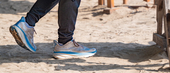 the stylish, sporty shoes with light and blue accents provide a point of interest against the...