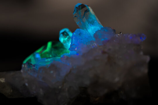 Natural quartz crystals in blue prism light