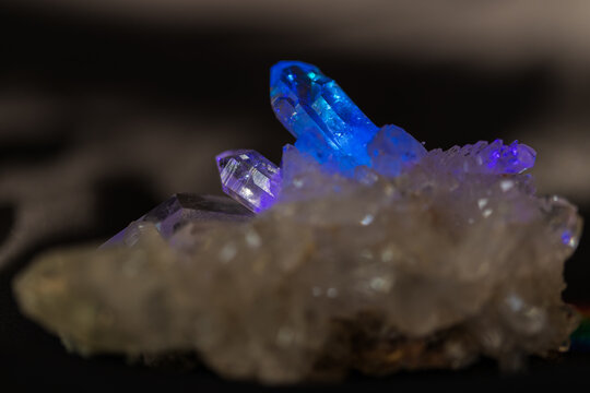 Natural quartz crystal cluster in blue prism light