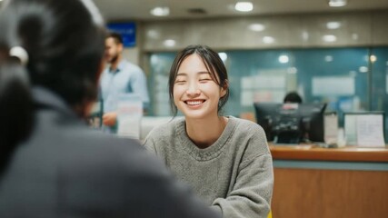 Bank Interaction: An image of a pleasant client interacting with a bank representative in a modern branch environment, highlighting concepts like financial services and customer satisfaction.