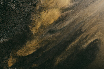 Abstract colorful smoke, dark background. Moving flow of golden black paints, fluid art, space sky