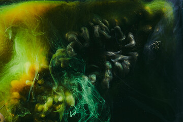 Abstract colorful smoke, dark background. Moving flow of yellow black paints, fluid art
