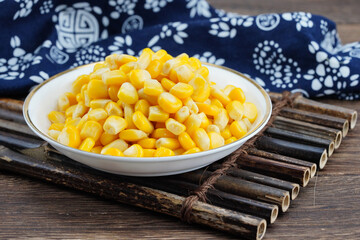 Yellow Corn Kernels on Plate and Cutting Board