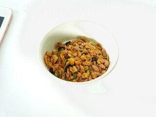 Granola mix grains Almonds bean on isolated white background. Food for energy breakfast, brunch snack. Healthy ingredients food contains nutrients protein, vitamins. Morning nutrition lifestyle food 