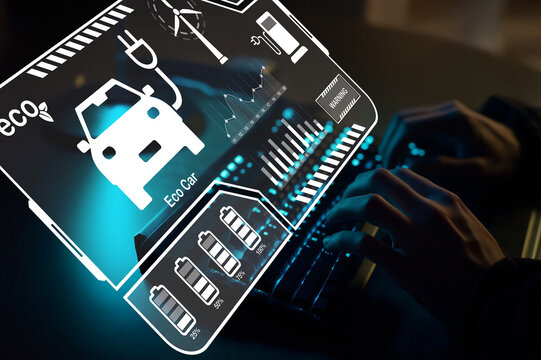 Hands Typing on Keyboard with Digital Display of Eco-Friendly Car Concepts and Battery Graphics for Sustainable Transport Technology Innovations