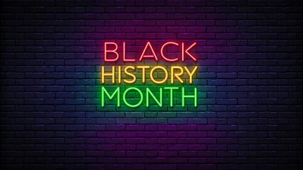 Obraz premium Colorful neon glowing black history month sign on dark brick wall background 