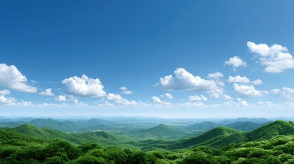 Fototapeta premium Breathtaking panoramic view of lush green hills under a bright blue sky with fluffy white clouds on a sunny day
