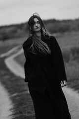 Naklejka premium Young woman feeling fresh wind. Autumn nature. Black and white portrait