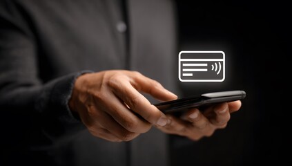Close-up of a businessman holding a smartphone with a glowing contactless digital payment card icon for NFC and mobile commerce