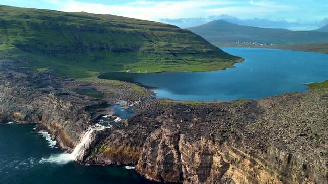 Explore the stunning landscape of Lake Sorvagsvatn surrounded by dramatic cliffs and lush greenery. This mesmerizing location showcases natures artistry amidst serene waters.