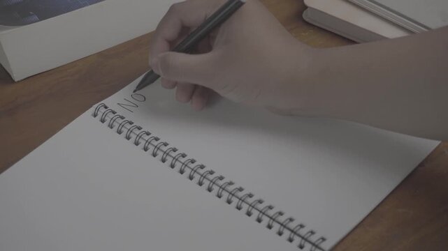 Person wrote "Notes Today" on his notebook. On a wooden table. S-Log3, S-Gamut3.Cine