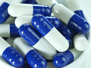 Many blue and white capsules.