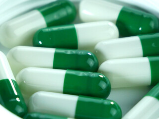 Many green and white capsules.