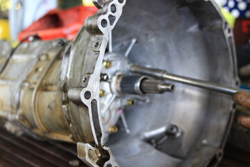 Gears or car parts being lifted out for repair.