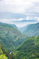 Fototapeta premium Breathtaking landscape of the Magdalena River Strait in San Agustin, Huila, Colombia, showcasing lush green hills and a misty atmosphere.