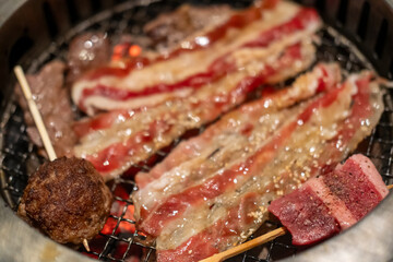 Sliced brisket on the  grill. BBQ rare meat with soft focus