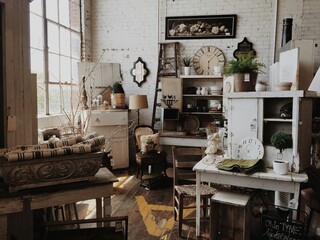 Old antique furniture arranged beautifully in a vintage-style room with soft lighting.
