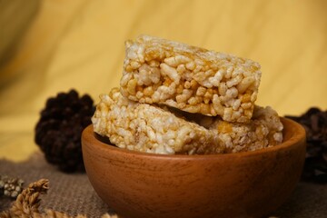 Crispy Jipang (Bipang) sweet rice crackers served in a wooden bowl on burlap with rustic natural decor, perfect for snack themes.
