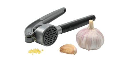 Garlic press with whole bulb and minced clove on black