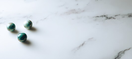 Green spheres on marble.