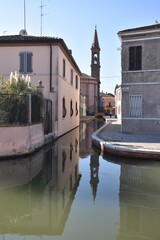 Canal in Comacchio (Italy) with the reflection of the bell tower