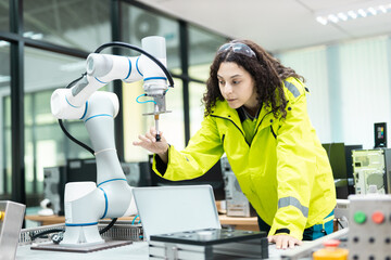 Female engineer testing collaborative robot (cobot) in high-tech smart lab, showcasing precision, automation, robotics engineering, and modern industrial innovation.