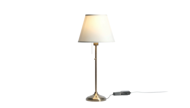Lit lamp with tan shade on simple metal stand, black background