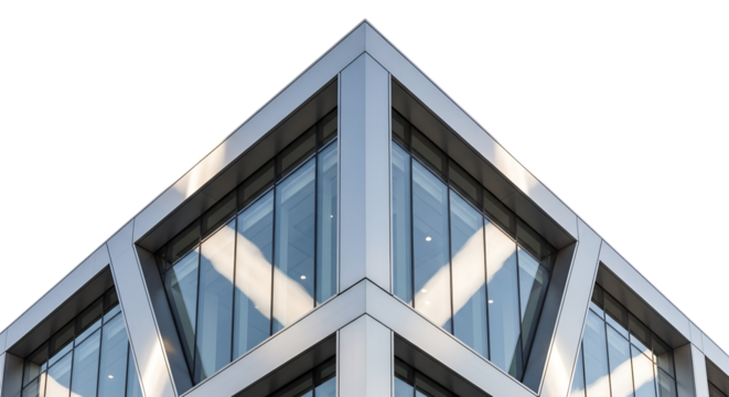 Modern office building corner with glass panels reflecting light  