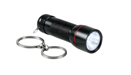 Black flashlight on a keychain, shining brightly