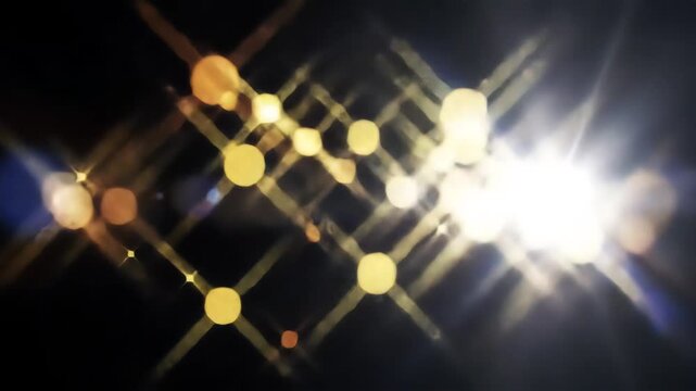 Abstract golden light particles and bright lens flare effect moving across a dark background creating a dynamic and energetic visual for intros and transitions.