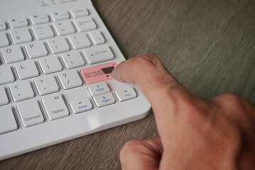 A finger presses a keyboard key labeled "BUY NOW PAY LATER" with a shopping cart icon. Installment payment options in e-commerce and online shopping concept.