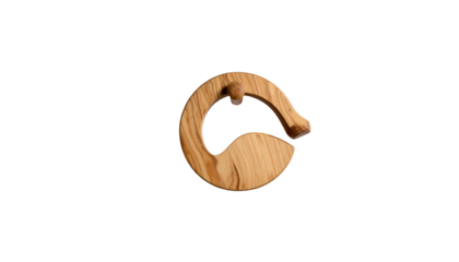 Wooden ring pull toy with a small ball, against a dark backdrop