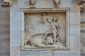 Detailed marble relief on the Duomo di Milano depicts the biblical story of David and Goliath with...
