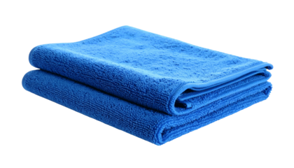 Stacked, folded, bright blue terrycloth towels on a dark background
