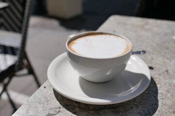 Enjoying coffee on a sunny day at a cafe