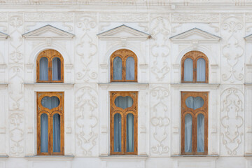 Fragment white wall of Sitorai Mokhi-Khosa Palace decorated arch windows and stucco in Bukhara, Uzbekistan. Sitorai Mokhi-Khosa or Palace Like the Stars and the Moon. Built 1912-1918.