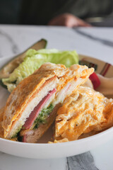 Egg and lettuce sandwich on a white plate