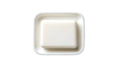 White soap bar sits in a glossy, square-shaped soap dish