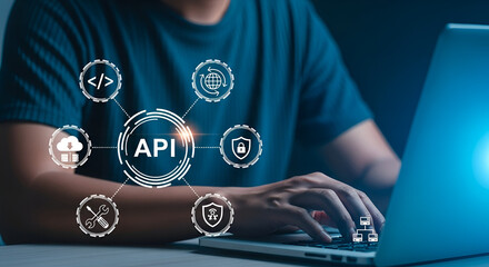 Developer interacting with API concept and related icons on a laptop
