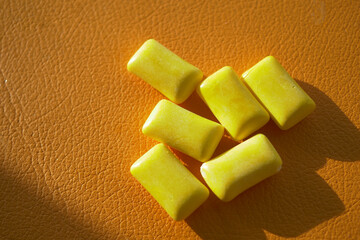 Colorful yellow chewing gum orange surface