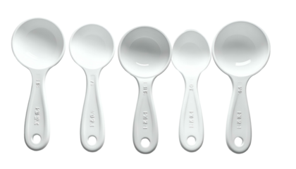 Five white ceramic measuring spoons in a row, different sizes