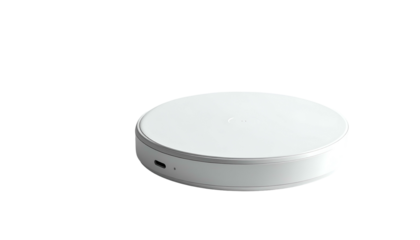 Round, white, tech charging pad on a black background