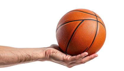 Hand holding a classic orange basketball against a black background
