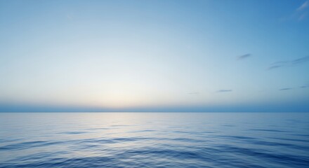 Calm ocean reflecting early morning sky with pale sunlight on the horizon and gentle ripples. Concept for peaceful meditation, travel destinations and nature backgrounds