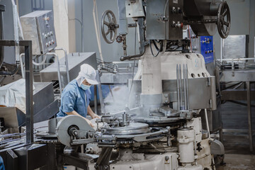 Quiet factory, plant worker cleaning production line convey belt prepare to close food factory