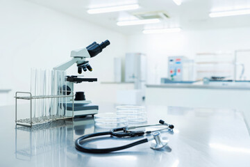 Microscope and stethoscope in a bright modern laboratory setting