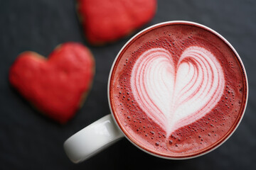 Red velvet latte with heart art and heart shaped cookies